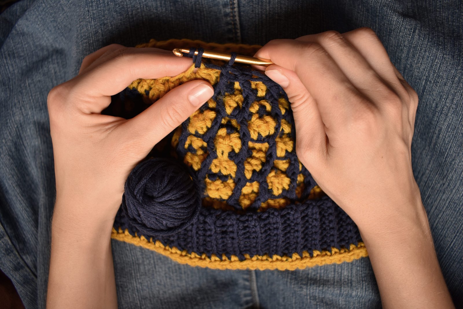 a young woman crocheting a hat