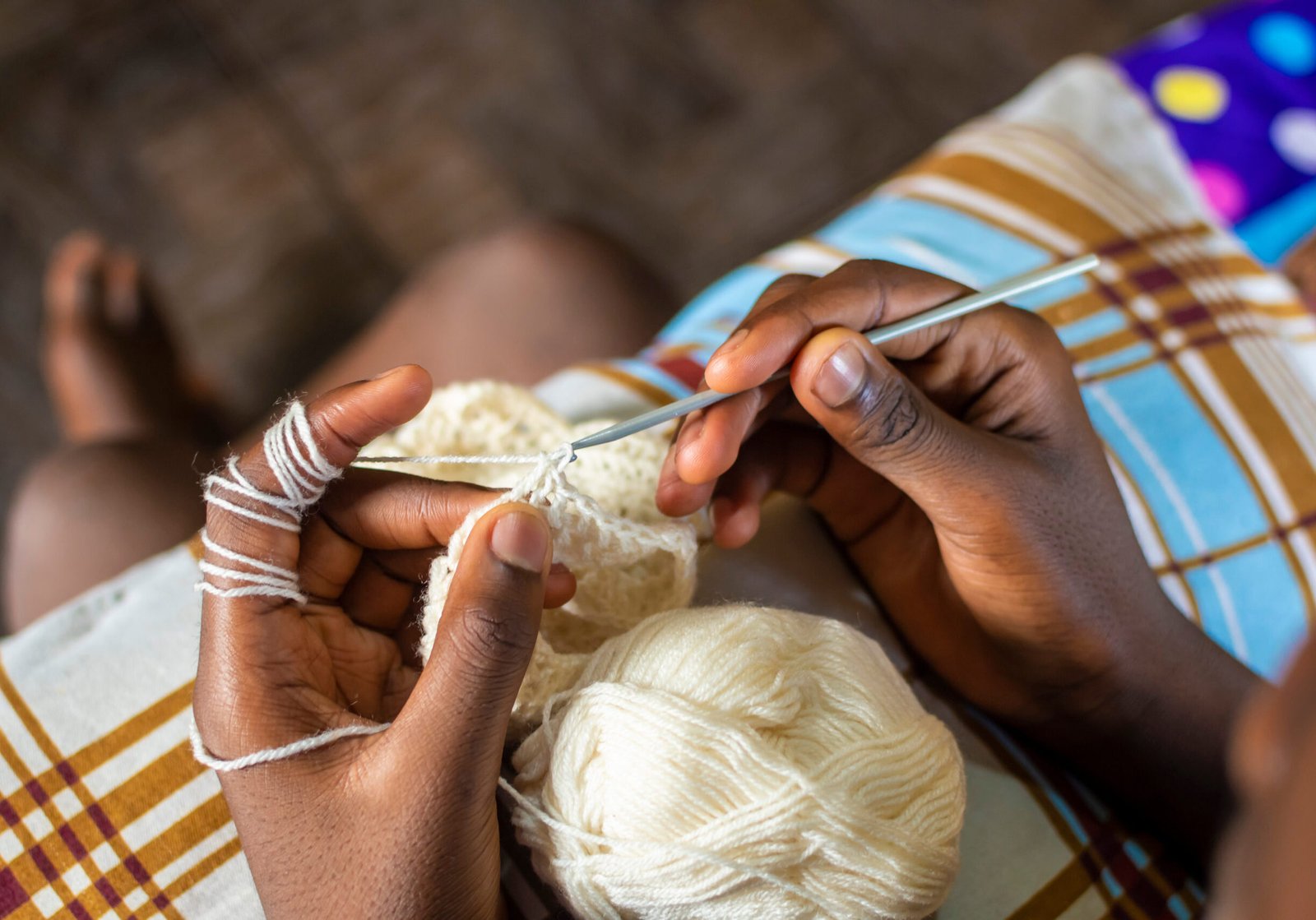 young african boy knitting, top view, hands only Person knitting Crochet